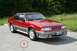2003 Ford Crown Victoria - A red 1991 Ford Mustang coupe is parked on an asphalt surface with a wooded area in the background.