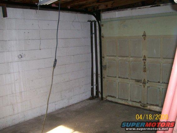 Garage interior with cinder block walls and a closed garage door. Date stamp reads 04/18/2009