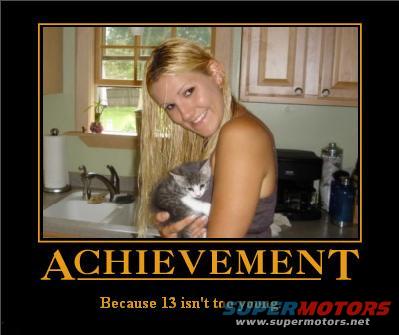 Woman holding a kitten in a kitchen, with text 'ACHIEVEMENT'