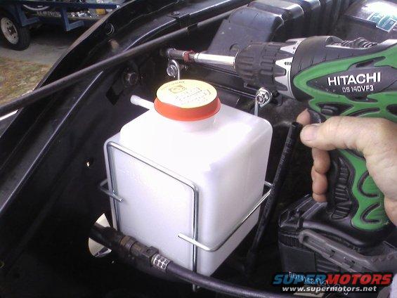 Hitachi drill installing a windshield washer fluid reservoir