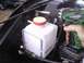 1978 Ford Bronco - Installing a new windshield washer fluid reservoir with a power drill.