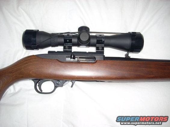 Rifle with scope mounted on wooden stock