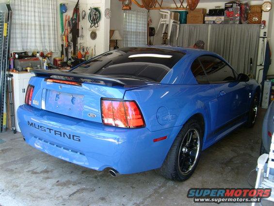 Blue Ford Mustang rear view. Body style indicates early 2000s model