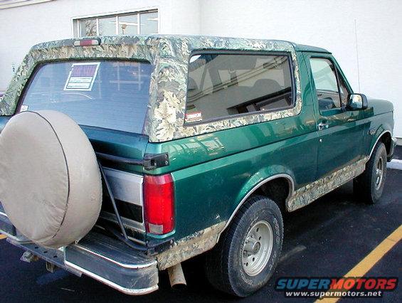 96-realtree.jpg '96 Eddie Bauer Bronco with camo wrap on all the tan exterior paint.  Note the aftermarket rear bumper that doesn't wrap forward along the body.

At the time I took this pic, I didn't know to look for the OHC, cargo cover, cargo net, or signal mirrors.