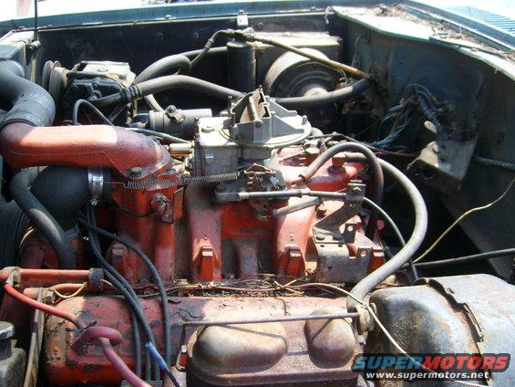 Engine bay with red engine block, carburetor, and hoses. Visible text: SUPERMOTORS