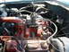 1994 Ford Bronco - Engine bay with visible engine components and hoses, showing some rust and wear.