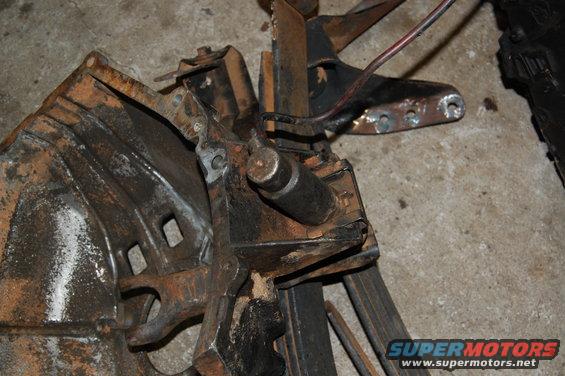 Rusted metal assembly with wires and bolts, close-up view
