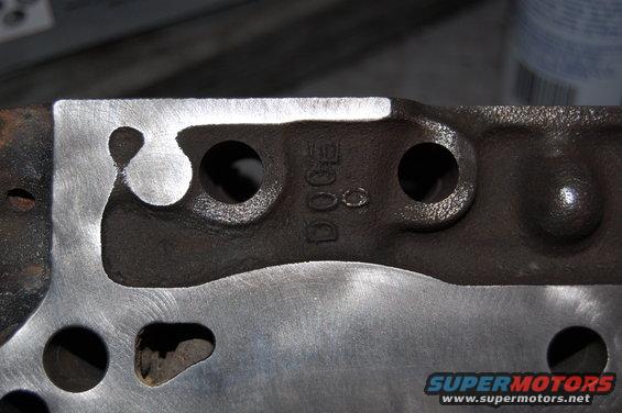 Engine part with 'DOGE' casting mark and machined surface