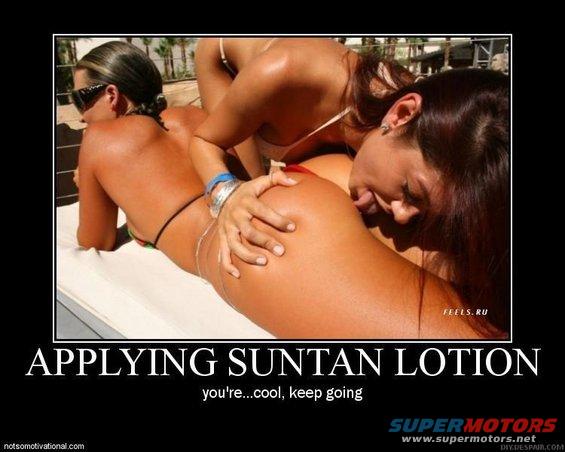 Two women sunbathing, one applying lotion to the other
