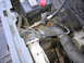 1987 Ford Bronco - Close-up of an engine compartment, focusing on the battery and various hoses.