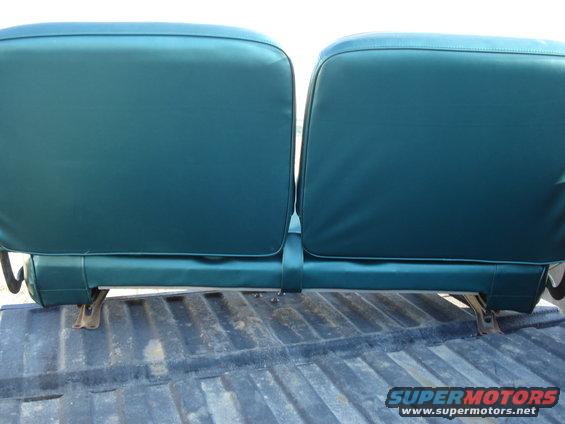 Back of two teal bench seats in a truck bed