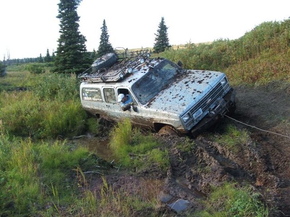1990 Chevrolet Suburban stuck in mud, winch line attached to front