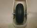 2003 Ford Crown Victoria - A close-up view of a small wheel and its mounting hardware within a white enclosure.