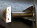 1996 Ford Bronco - A close-up view of a fabricated metal part, showing welds and mounting holes.