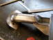 1996 Ford Bronco - A close-up view of a fabricated metal suspension part, showing the details of its construction.