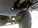 1996 Ford Bronco - Close-up view of a vehicle's underbody skid plate and suspension system.