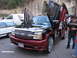 2001 Chevrolet Silverado 1500 - This modified Chevrolet pickup truck features custom butterfly doors and a distinctive grille, parked alongside other vehicles.