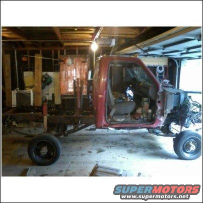 1994 Ford F-250 chassis with cab, missing front clip and bed, in a garage