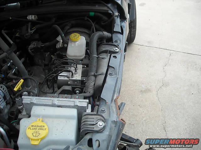 Engine bay with washer fluid reservoir and brake fluid reservoir visible