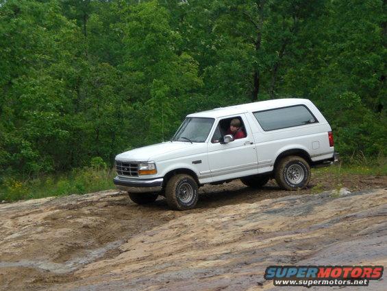 White 1992 Ford Bronco driving off-road