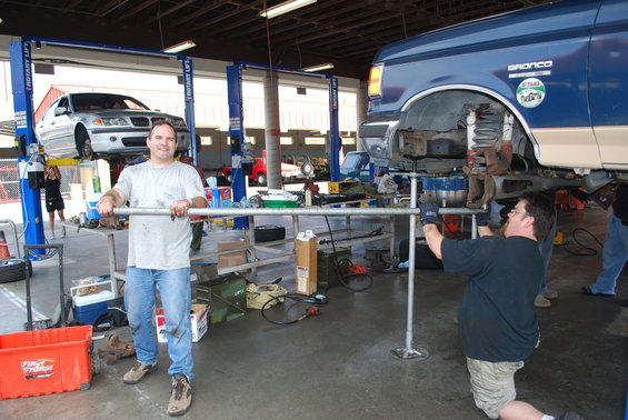 Blue Ford Bronco on lift with "Bronco" text visible on side