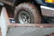 1995 Ford Bronco - Muddy tire and fender of a 1995 Ford Bronco after off-roading.