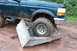 1995 Ford Bronco - Ford Bronco stuck on a couch cushion while off-roading in the mud.