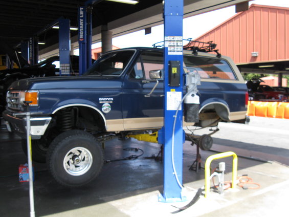 Blue 1986 Ford Bronco on a lift with tan trim