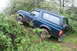 1995 Ford Bronco - This 1995 Ford Bronco navigates a muddy, overgrown trail.