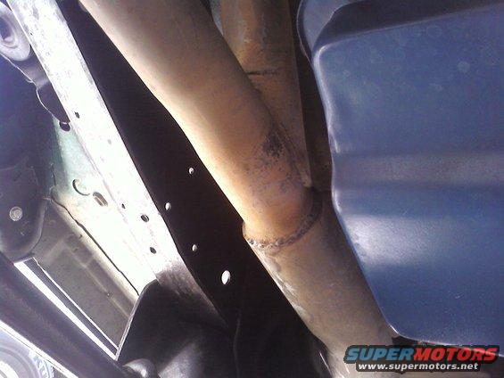 Close-up of exhaust pipe and vehicle frame components