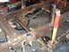 1994 Ford F-250 - Close-up of a heavily rusted truck frame with suspension components visible.