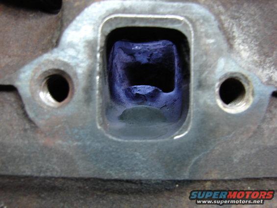 Exhaust port. Notice two bumps, one is for valve, the other had no use for me.  It had to go.  Also, you can see the outline that I will port out.