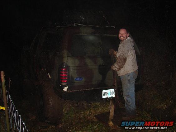 guy next to a muddy 1996 Ford Bronco with camouflage paint