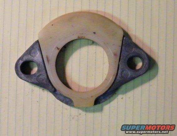 Automotive part with metal and plastic components on lined paper
