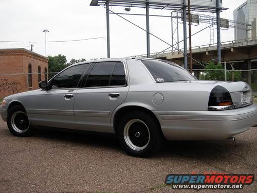 Silver 1998 Ford Crown Victoria, side view, black wheels