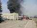 1996 Dodge 2500 - Emergency vehicles are on the scene of a fire, with thick black smoke billowing into the sky.