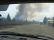 1996 Dodge 2500 - Fire trucks are seen on a road with a large plume of smoke rising in the distance, indicating a significant fire.