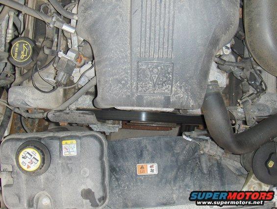 Engine bay with coolant reservoir and air intake housing