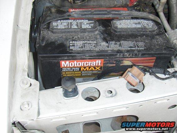 Motorcraft car battery in engine bay. Shows danger/poison warnings and 36-month/100-month service life