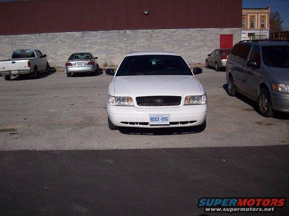 White 2003 Ford Crown Victoria front view with license plate BOXX-896