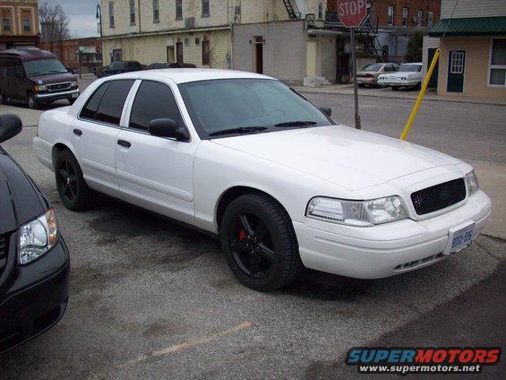 White 2003 Ford Crown Victoria, 3/4 front view, black wheels