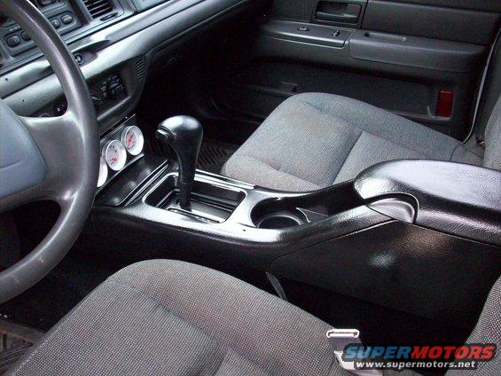 Interior view with two gauges and gear shifter