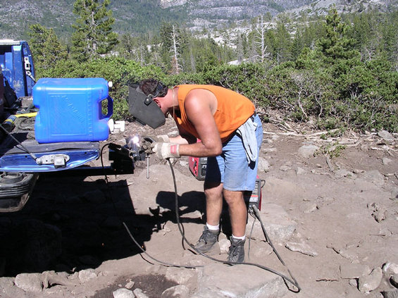 billweld.jpg bill lost his custom 16 spline front drive line.  It was supposed to be splined into the flange and wasnt, so he spun the weld.  here he is trying to reweld it, before the flange finally let go.  I ended up pulling him a lot of the way out (up cadillac and down from buck lake thru the big sluice).  Lots of his good driving and some winching got him off the trail this trip