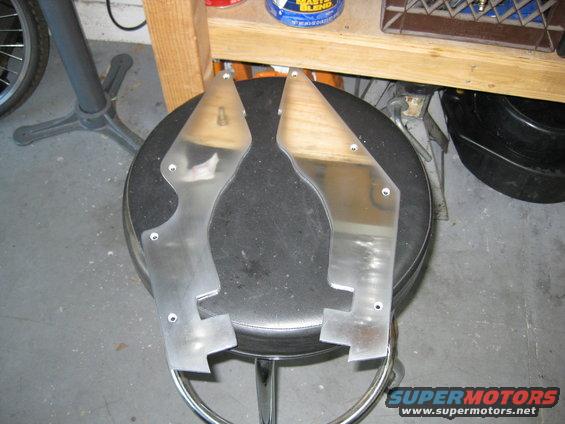 Pair of metal and wood hydrofoil parts on a stool