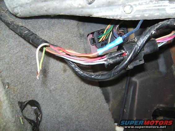 sany1241.jpg Couple things to see here that are wrong.
#1 Gray & Grn/Org wires spliced together. (why?) note: there was a butt connector, i removed it.
#2 Red/Lt Blu hooked to a solid blue wire, that actually goes right to a  12 in the fuse box, no fuse, just constant hot. (Again, why?)
#3, the 8-pin plug in the background is missing one end of the plug! The wires have been removed and individually inserted into their correct pin.  God only knows why, but i know the previous owner wasnt good with electronics!  See next pic for some solutions.