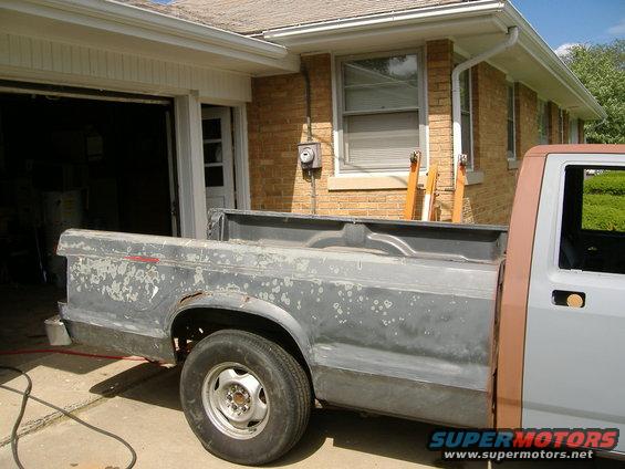 Gray truck bed with peeling paint, side view