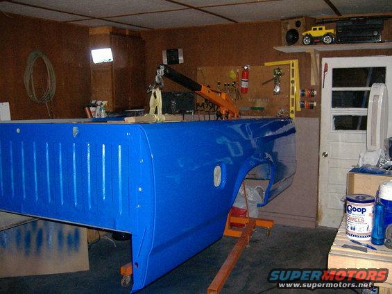 Blue 1992 Dodge Dakota truck bed on an engine hoist in a garage