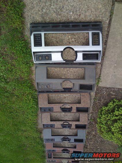 Stack of dashboard trim pieces with various finishes