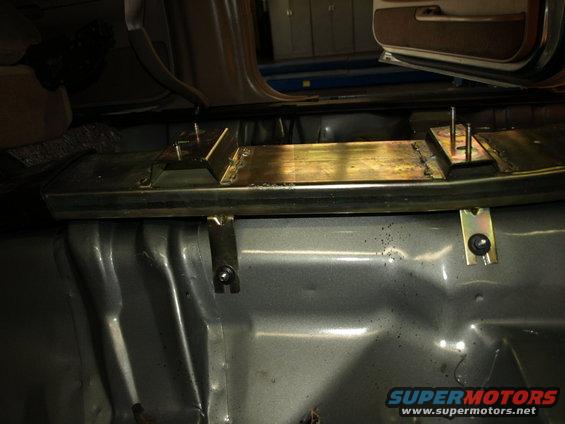 Interior view of metal bracing installed on the floor of a vehicle