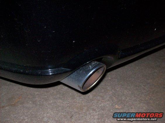Black car exhaust pipe with 'BORLA' etched on it
